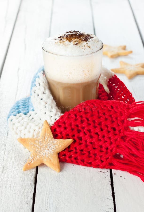 Winter latte coffee in white tall glass with christmas cookies