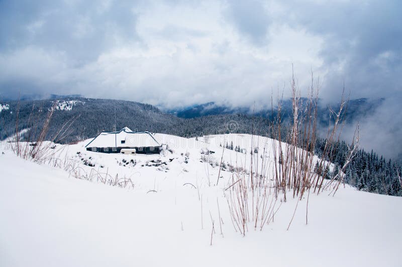 Winter lodge among mountains royalty free stock photo
