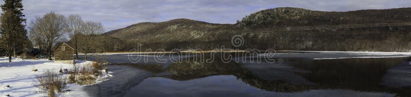 Winter mountain lake scene with cabin in Berkshires