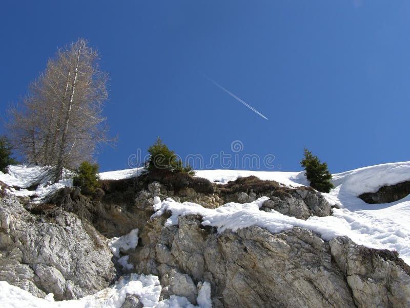 Winter mountain landscape, airplane track