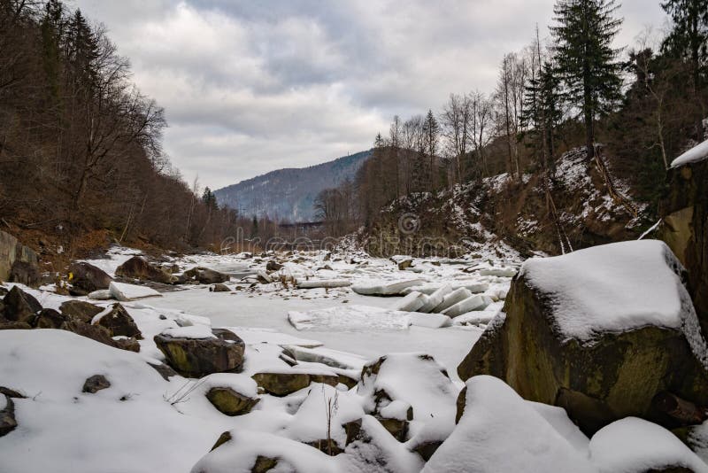 Winter mountain river ander the snow, stouns, pines, winter sky, cold, frozen river in the mountaines