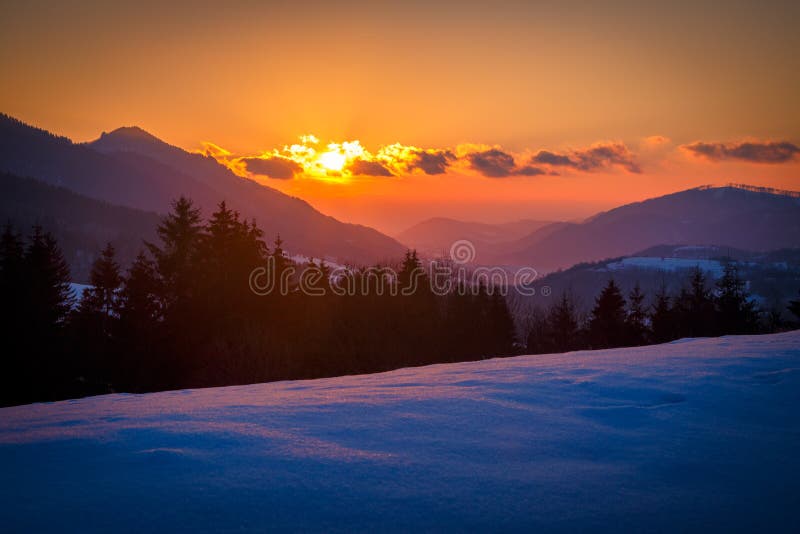 Winter mountain snowy landscape at sunset