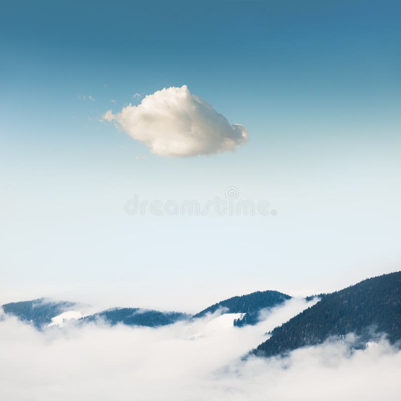 Winter mountains and lonely cloud in the sky stock image