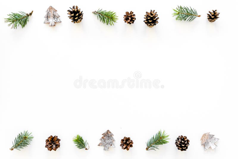 Winter ornament, New Year pattern. Pine sprigs, cones, spruce figure, fir oil on white background top view copy space stock photography Winter ornament, New Year pattern. Pine sprigs, cones, spruce figure, fir oil on white background top view copy space stock photography
