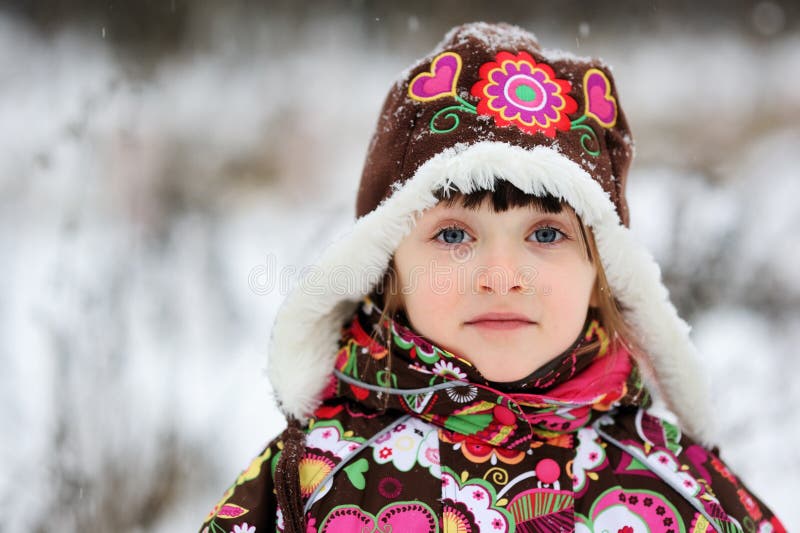 Winter portrait of child girl in snowsuit