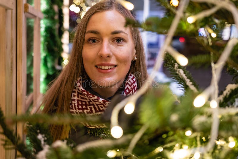 Winter portrait of happy young woman walking in snowy city decorated for Christmas and New Year holidays. stock image Winter portrait of happy young woman walking in snowy city decorated for Christmas and New Year holidays. stock image