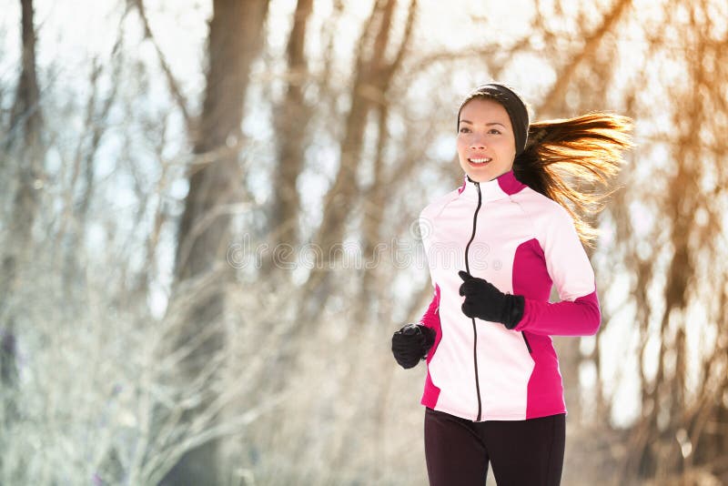 Winter run woman runner exercising in forest park
