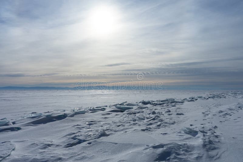 Winter sea day. Chunks of blue ice. Panoramic view of the snow-covered shore of the frozen sea, the lake on a winter, spring day.