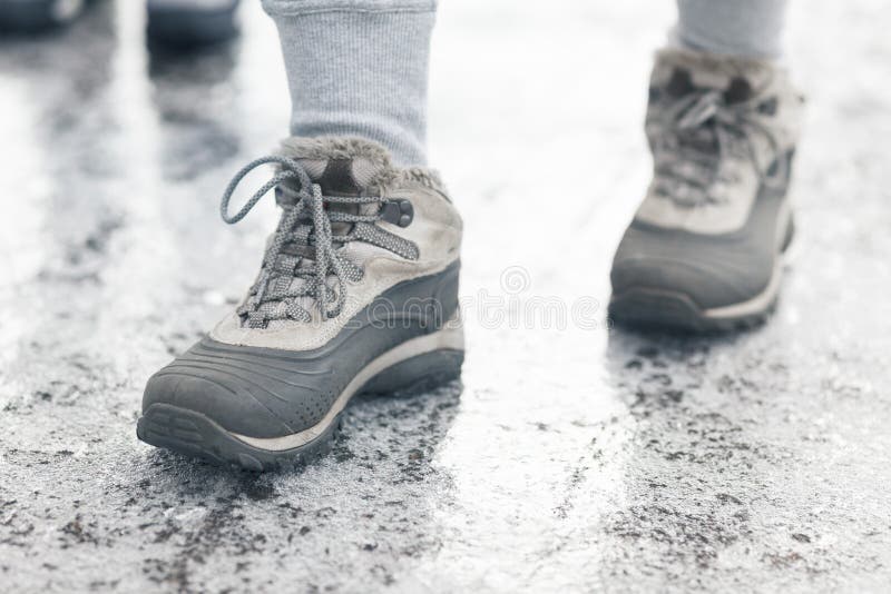 Winter shoes on the icy, frozen sidewalk. Dangerous weather