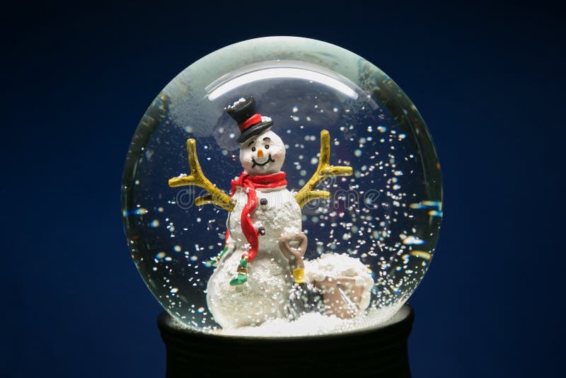 Winter Snow Globe With Snowman on Blue stock photos Winter Snow Globe With Snowman on Blue stock photos