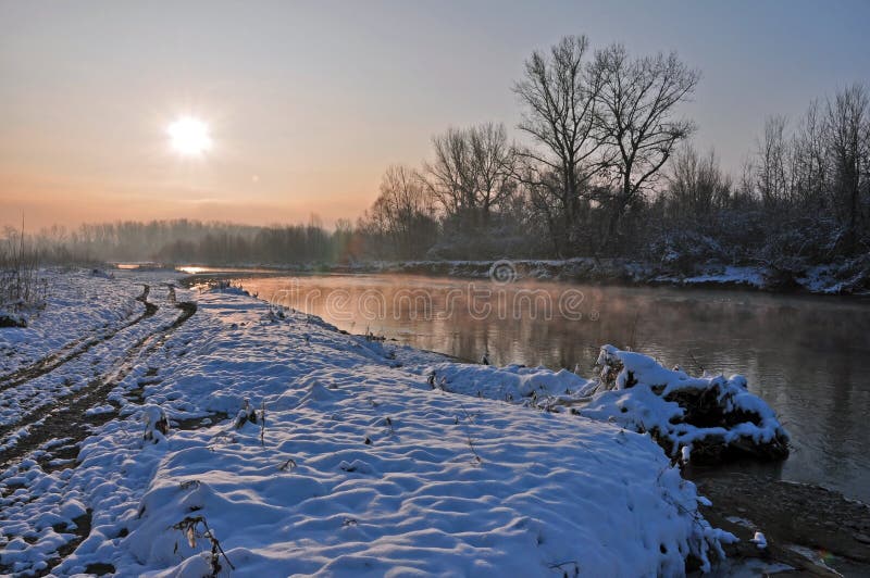 Winter sunrise over snowy river