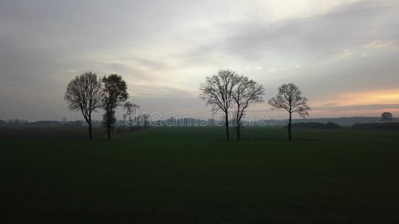 Winter sunset drone over farm field