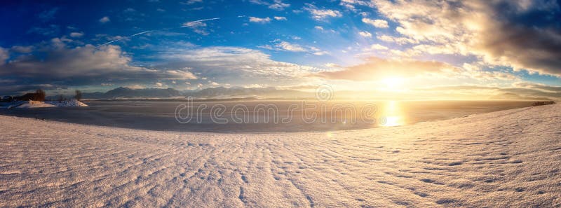 Winter sunset landscape with lake, mountains, snow, sky and sun, Liptovska Mara, Slovakia