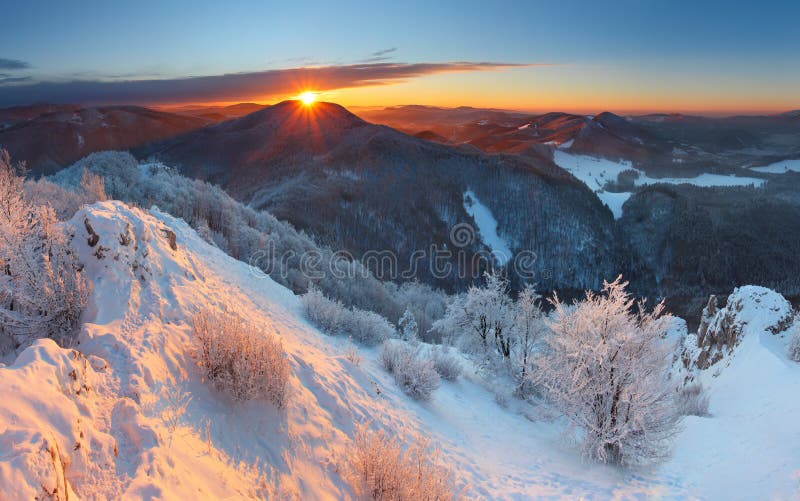 Winter sunset in mountain with clouds