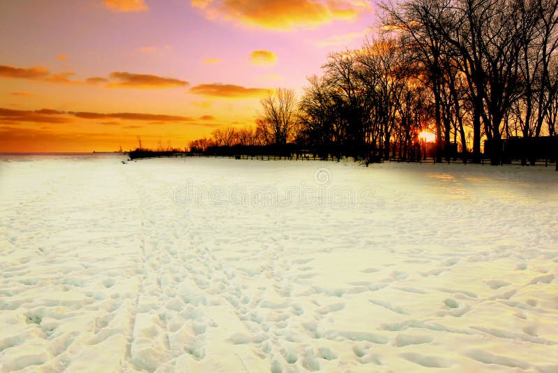 Winter sunset over snow covered beach