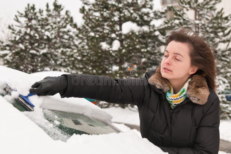 Winter time - person cleaning car