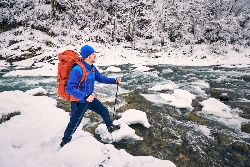 Winter Hike with a Backpack in a Mountainous Area Near the River Stock