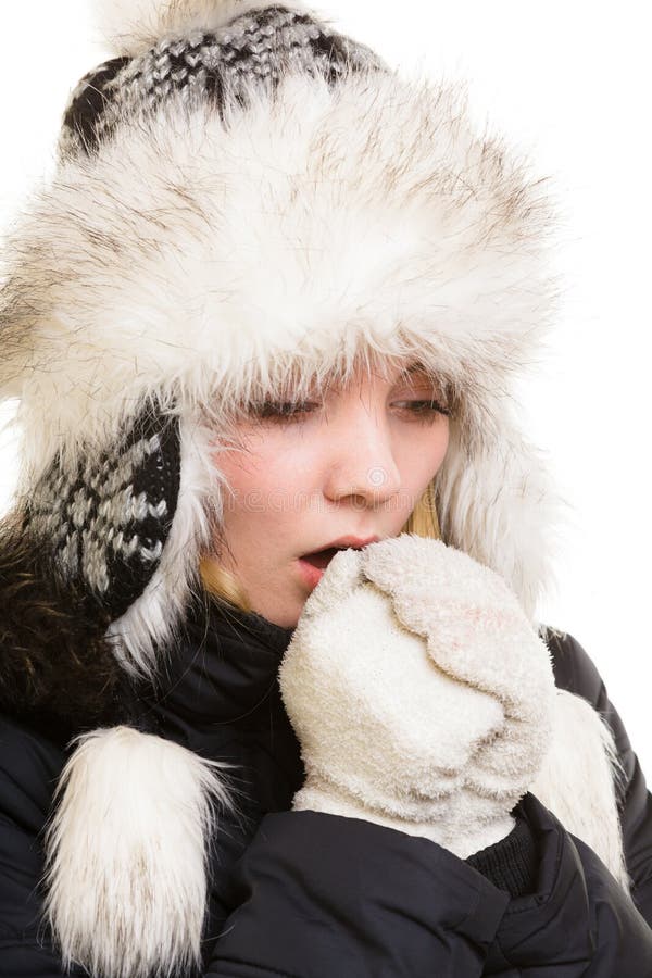 Winter vacation. Freezing girl warming her hands. stock photo Winter vacation. Freezing girl warming her hands. stock photo