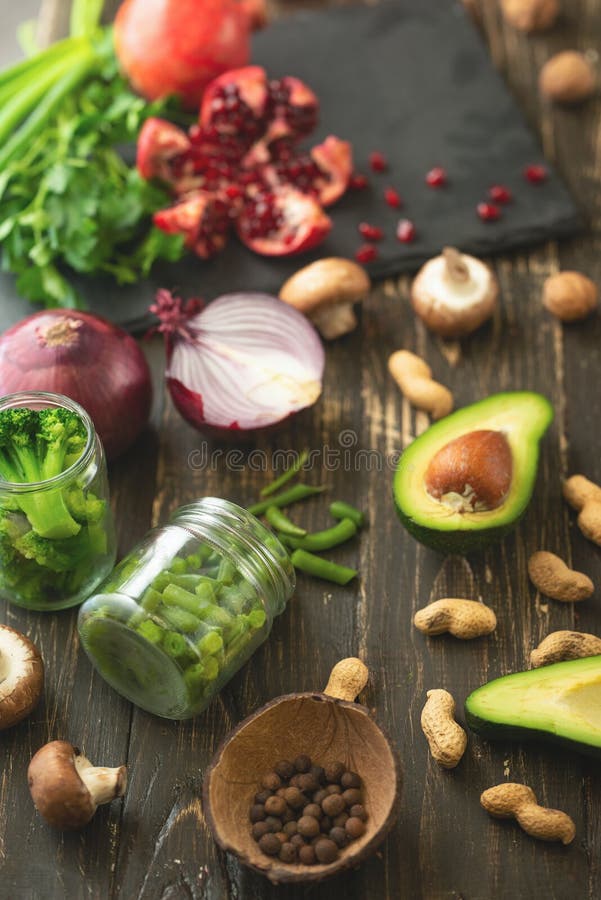 Winter vegetarian, vegan food cooking ingredients. Flat lay of vegetables, fruits, beans, kitchen utensils, olive oil on a wooden stock image Winter vegetarian, vegan food cooking ingredients. Flat lay of vegetables, fruits, beans, kitchen utensils, olive oil on a wooden stock image