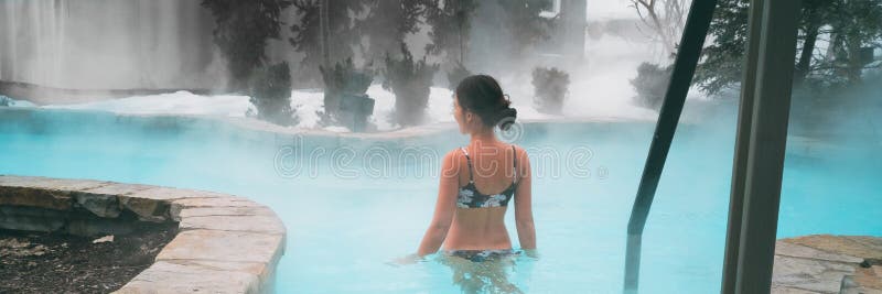 Winter wellness spa resort woman swimming in hot spring thermal pools bath at luxury health center panoramic banner stock photos Winter wellness spa resort woman swimming in hot spring thermal pools bath at luxury health center panoramic banner stock photos