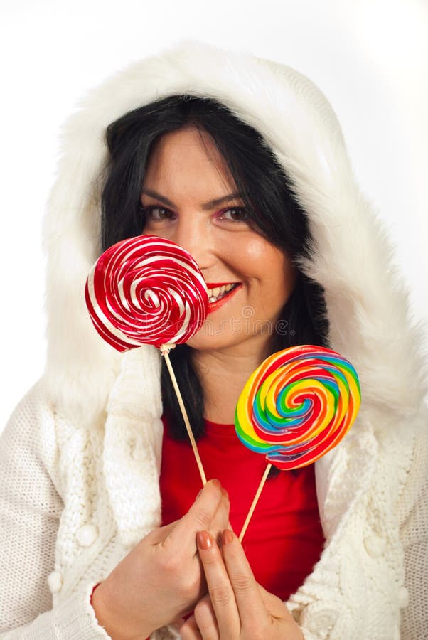 Winter woman holding lollipops stock photo