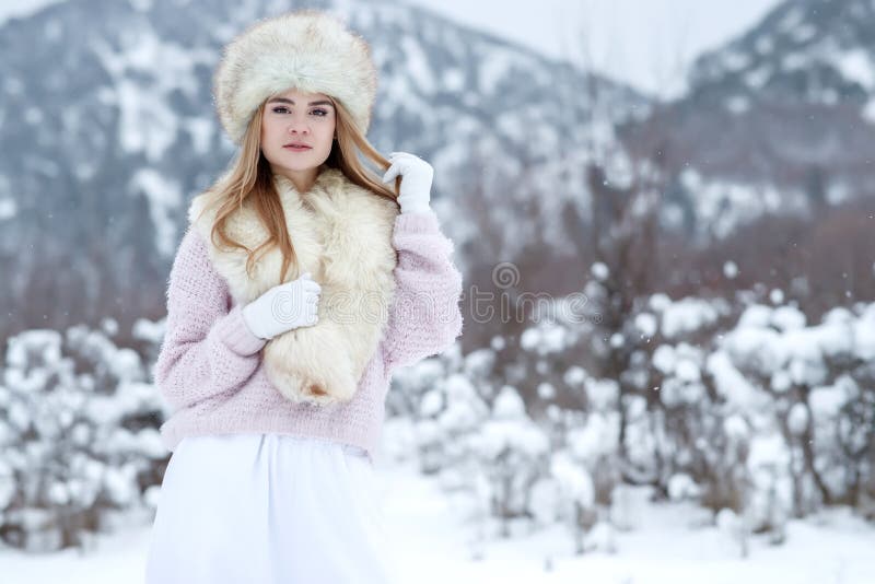 Winter Woman in the Snow. Beautiful Girl in the Winter in Nature