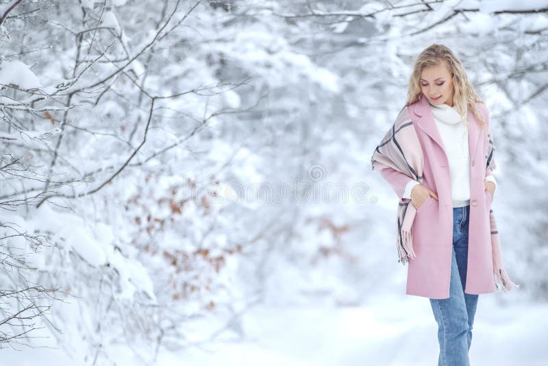 Winter woman in the snow. Beautiful girl in the winter in nature