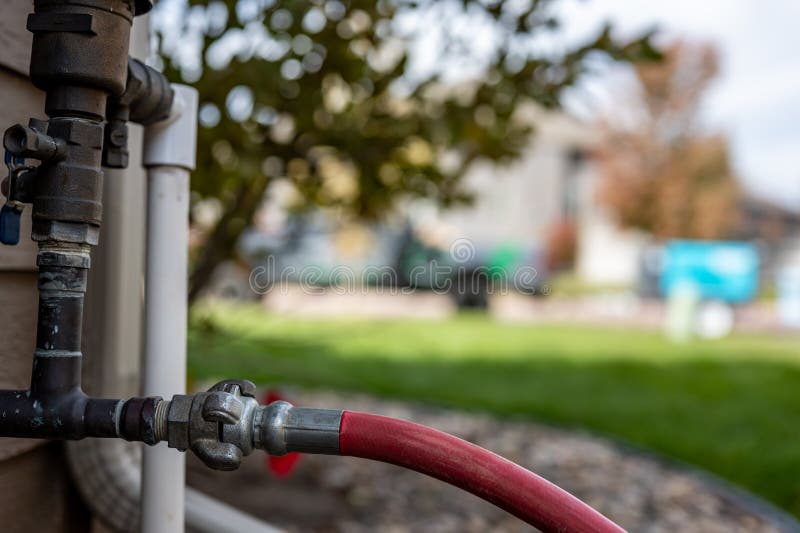 Winterizing a residential irrigation system by using a compressor and forced air to blow the lines empty. royalty free stock images