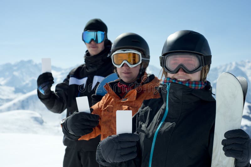 Group of winter sport people showing ski lift pass looking. Concept to illustrate ski admission fee. Group of winter sport people showing ski lift pass looking. Concept to illustrate ski admission fee