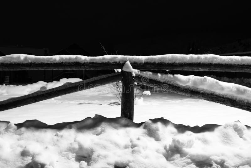 Wintertime fallen snow on wooden fence motif at night royalty free stock photos Wintertime fallen snow on wooden fence motif at night royalty free stock photos