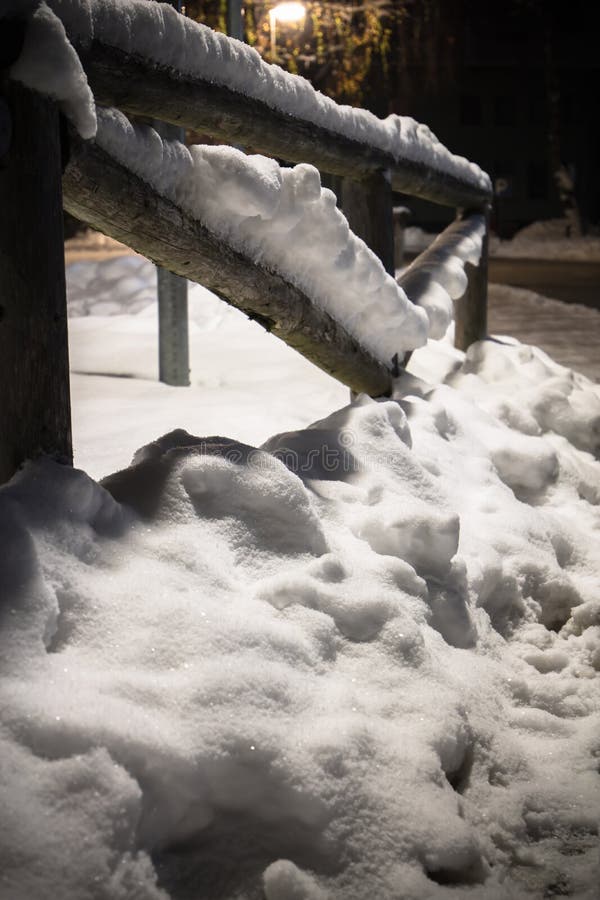 Wintertime fallen snow on wooden fence motif at night royalty free stock photography Wintertime fallen snow on wooden fence motif at night royalty free stock photography