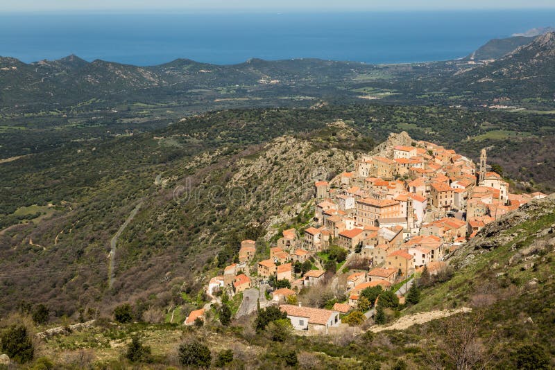 The mountain village of Speloncato in the Balagne region of north Corsica with maquis and the Mediterranean in the background. The mountain village of Speloncato in the Balagne region of north Corsica with maquis and the Mediterranean in the background