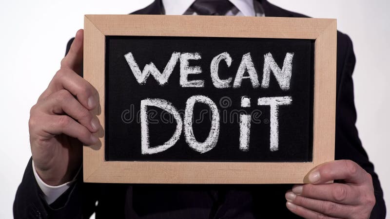 Wir können es tun Motivationsphrase auf Tafel in den Geschäftsmannhänden, Unterstützung lizenzfreie stockfotos Wir können es tun Motivationsphrase auf Tafel in den Geschäftsmannhänden, Unterstützung lizenzfreie stockfotos