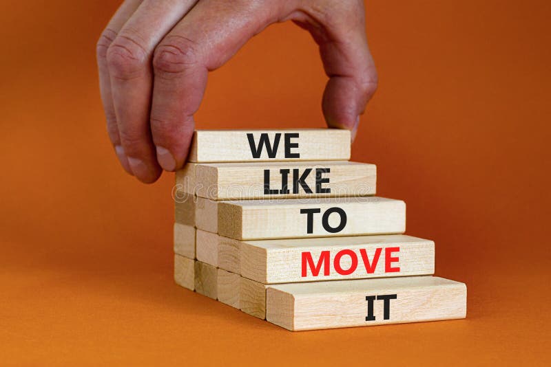 We like to move it symbol. Concept words We like to move it on wooden blocks. Businessman hand. Beautiful orange table orange background. Business motivational We like to move it concept. Copy space. We like to move it symbol. Concept words We like to move it on wooden blocks. Businessman hand. Beautiful orange table orange background. Business motivational We like to move it concept. Copy space