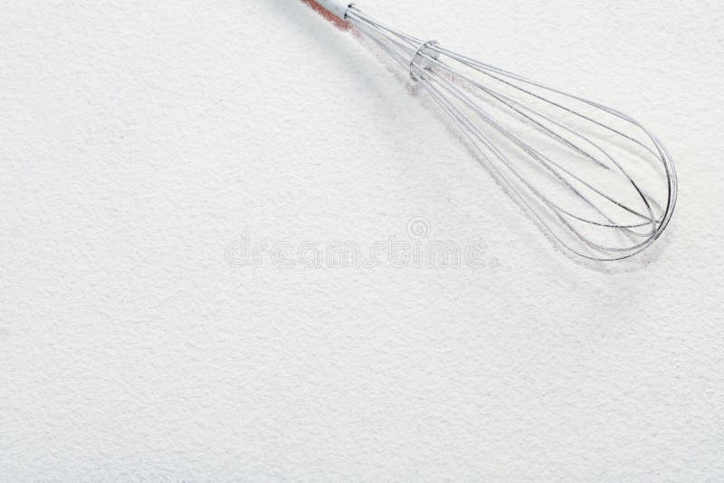 Wire whisk on flour