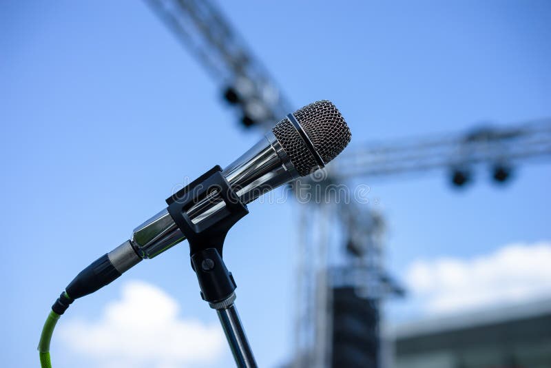 Wired microphone stand on the outdoor venue. Wired microphone stand on the outdoor venue