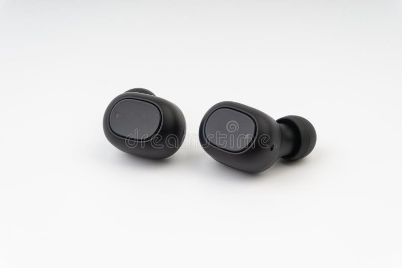 Wireless earbuds or earphones on white background. Selective focus