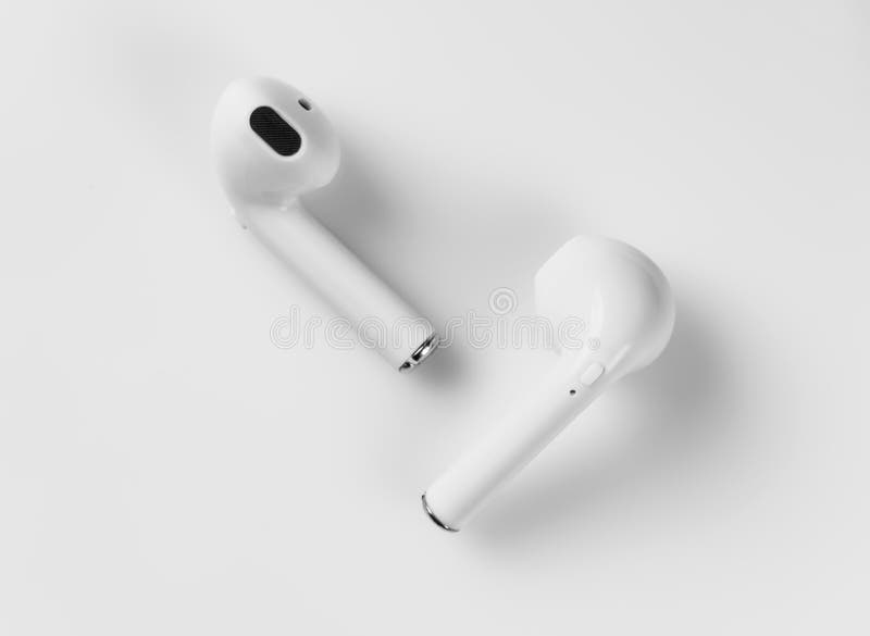 White wireless headphones are on a white background. Macro. White wireless headphones are on a white background. Macro