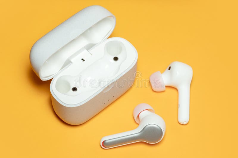 Wireless Headphones on a Yellow Background with Case. Bluetooth Stock