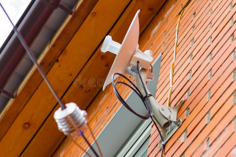 Wireless Receiver Antenna on a Brick Wall at Home Stock Photo