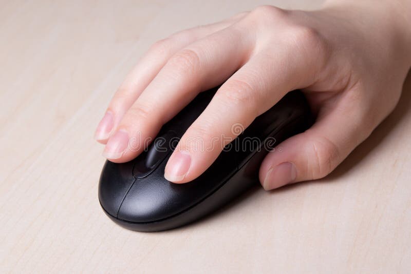 Wireless mouse in hand on table