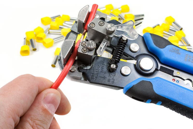 Wires stripper in master hand and cord end terminals on a white background stock photos