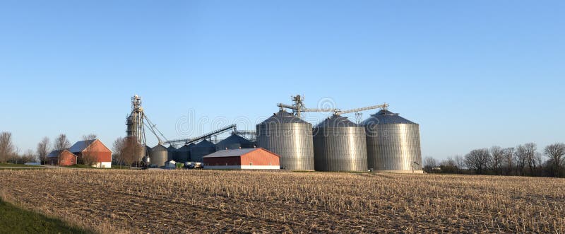 Grain elevator silos on a Wisconsin dairy farm. This is a large panorama or panoramic banner type image. The dairy industry is big agriculture business in Wisconsin. Grain elevator silos on a Wisconsin dairy farm. This is a large panorama or panoramic banner type image. The dairy industry is big agriculture business in Wisconsin.