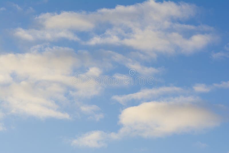 Wispy White Clouds Against a Blue Sky. Background Suitable Stock Photo