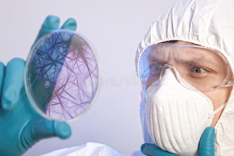 Scientist holding a petri dish with virus cells. Virus concept. Scientist holding a petri dish with virus cells. Virus concept