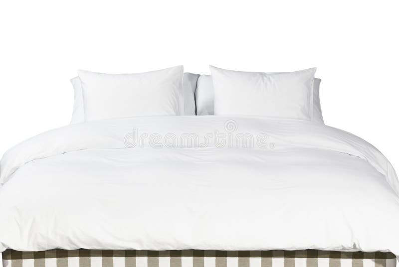 Witte hoofdkussens en deken op een bed