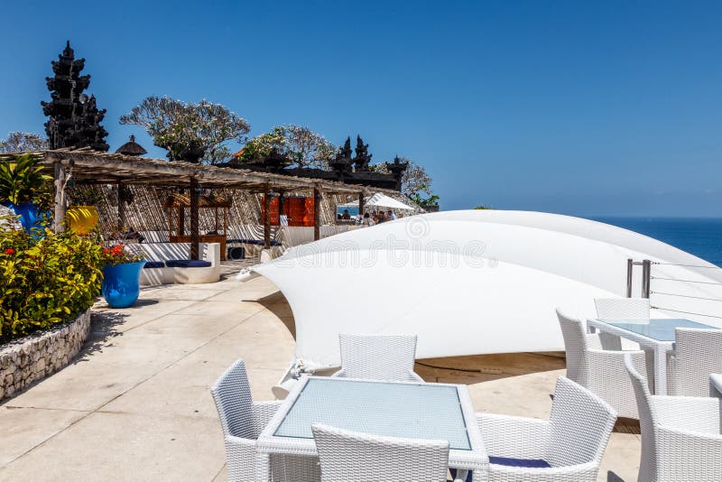Witte lijsten en stoelen bij een openluchtklippenkoffie met oceaanmening stock foto's Witte lijsten en stoelen bij een openluchtklippenkoffie met oceaanmening stock foto's