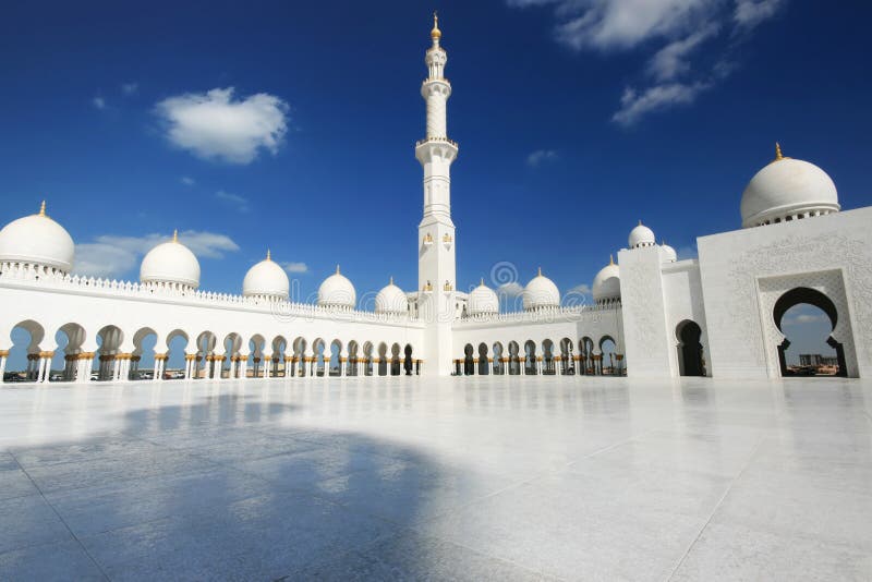 White mosque in Abu Dhabi against cloudy blue sky. White mosque in Abu Dhabi against cloudy blue sky