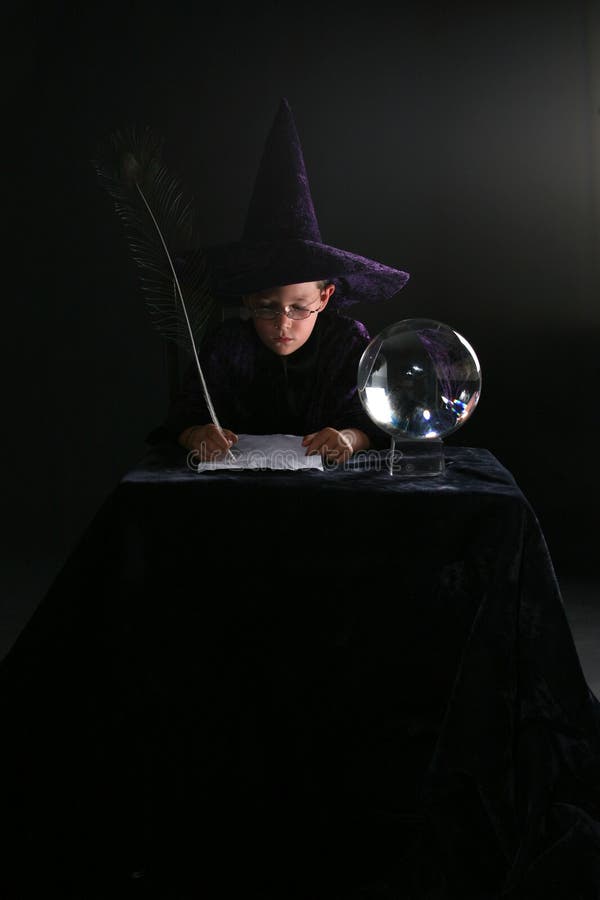 Wizard boy writing a spell