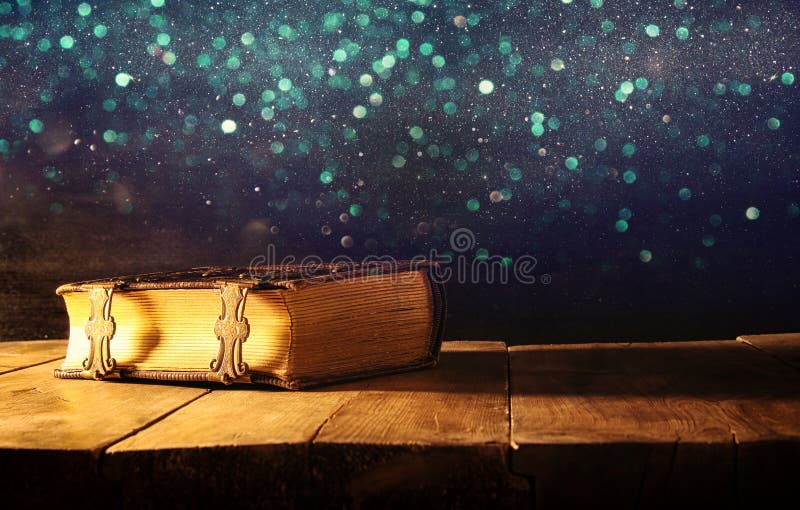 Image of antique books, with brass clasps on old wooden table. fantasy medieval period and religious concept. Image of antique books, with brass clasps on old wooden table. fantasy medieval period and religious concept